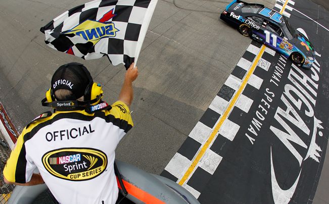 Denny Hamlin crosses the finish line to win the Heluva Good Sour Cream Dips 400 at Michigan International Speedway. Credit: Chris Graythen/Getty Images